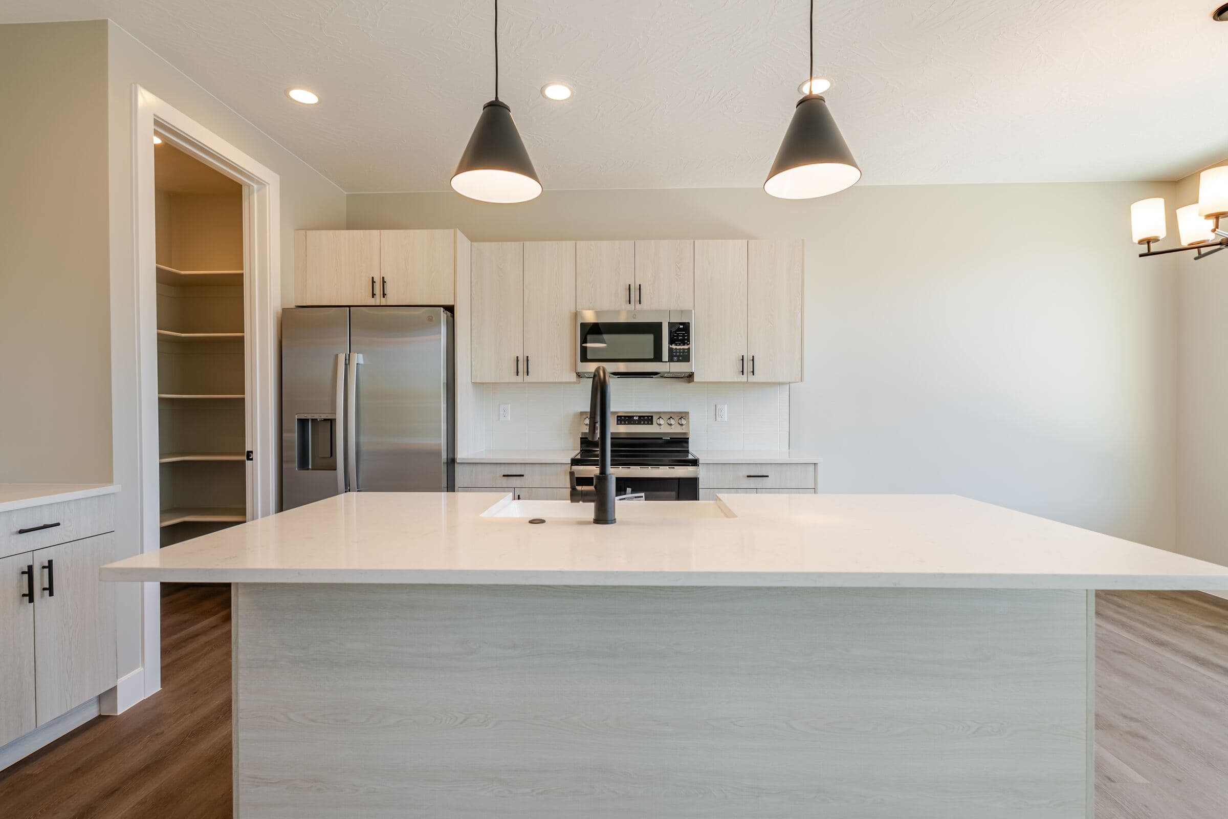 Kitchen island and quartz countertops open to the great room