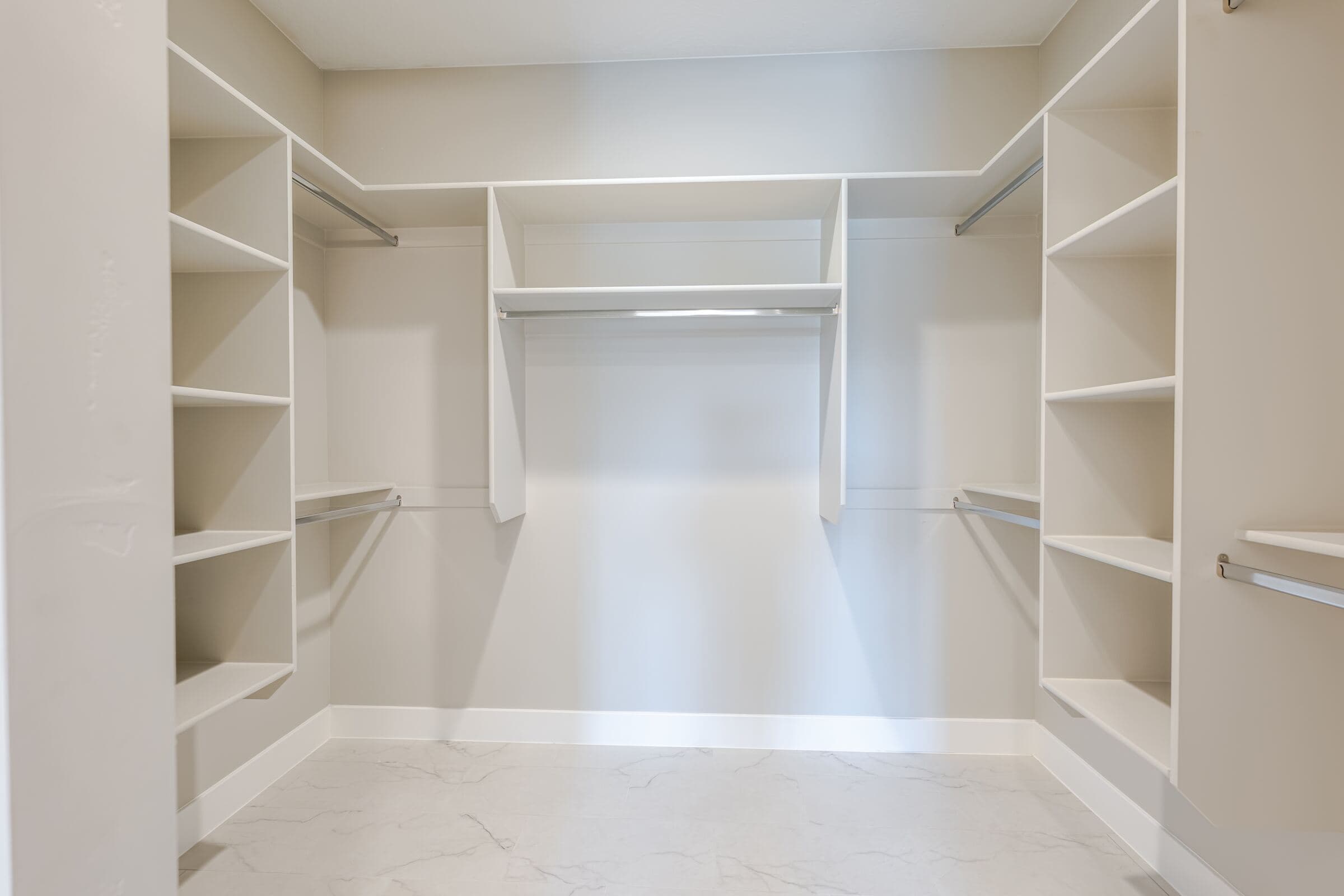 Primary walk-in closet with adjustable shelving