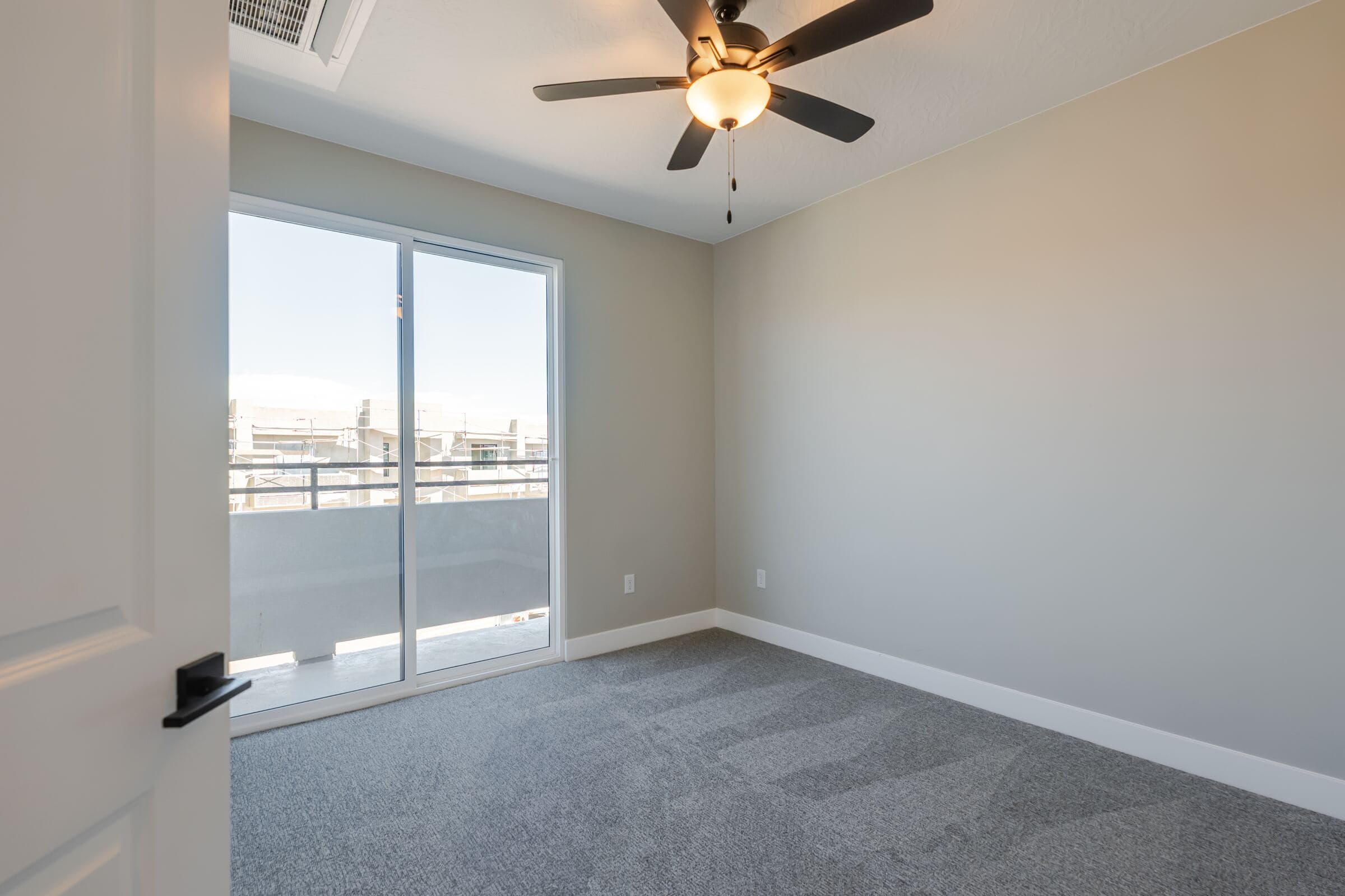 Bedroom with sliding glass door to a private balcony
